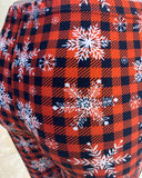 White snowflakes over plaid leggings